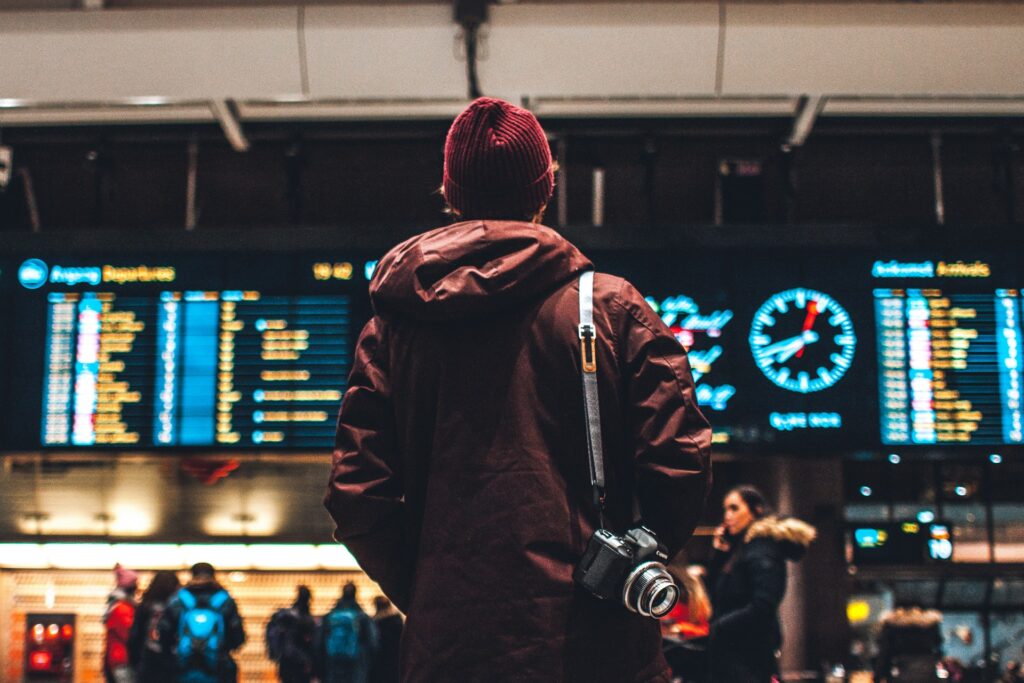 A person watching an airport departure board