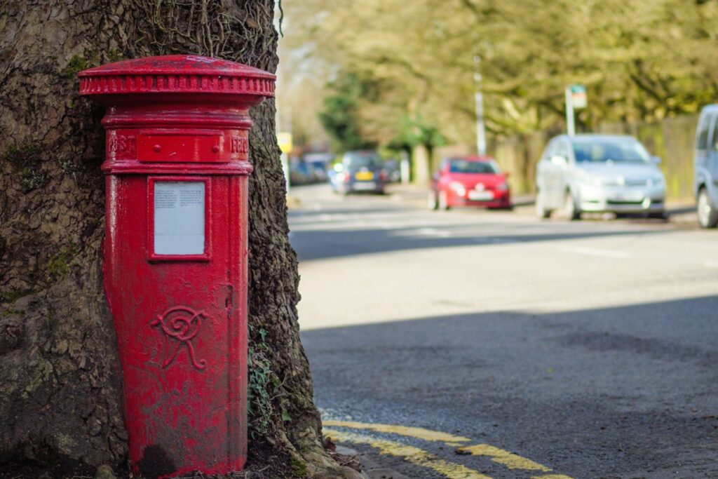 A letterbox beside a tree