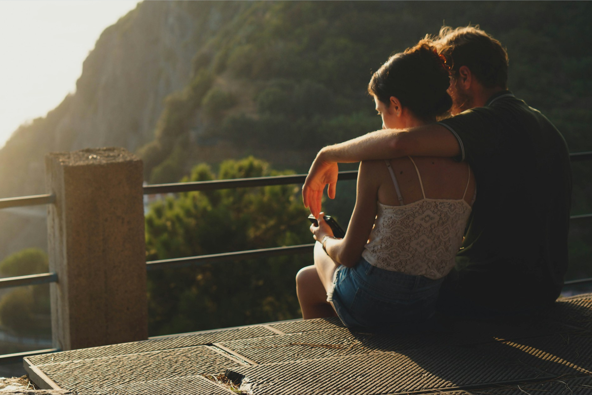 A couple sitting together overlooking a mountain