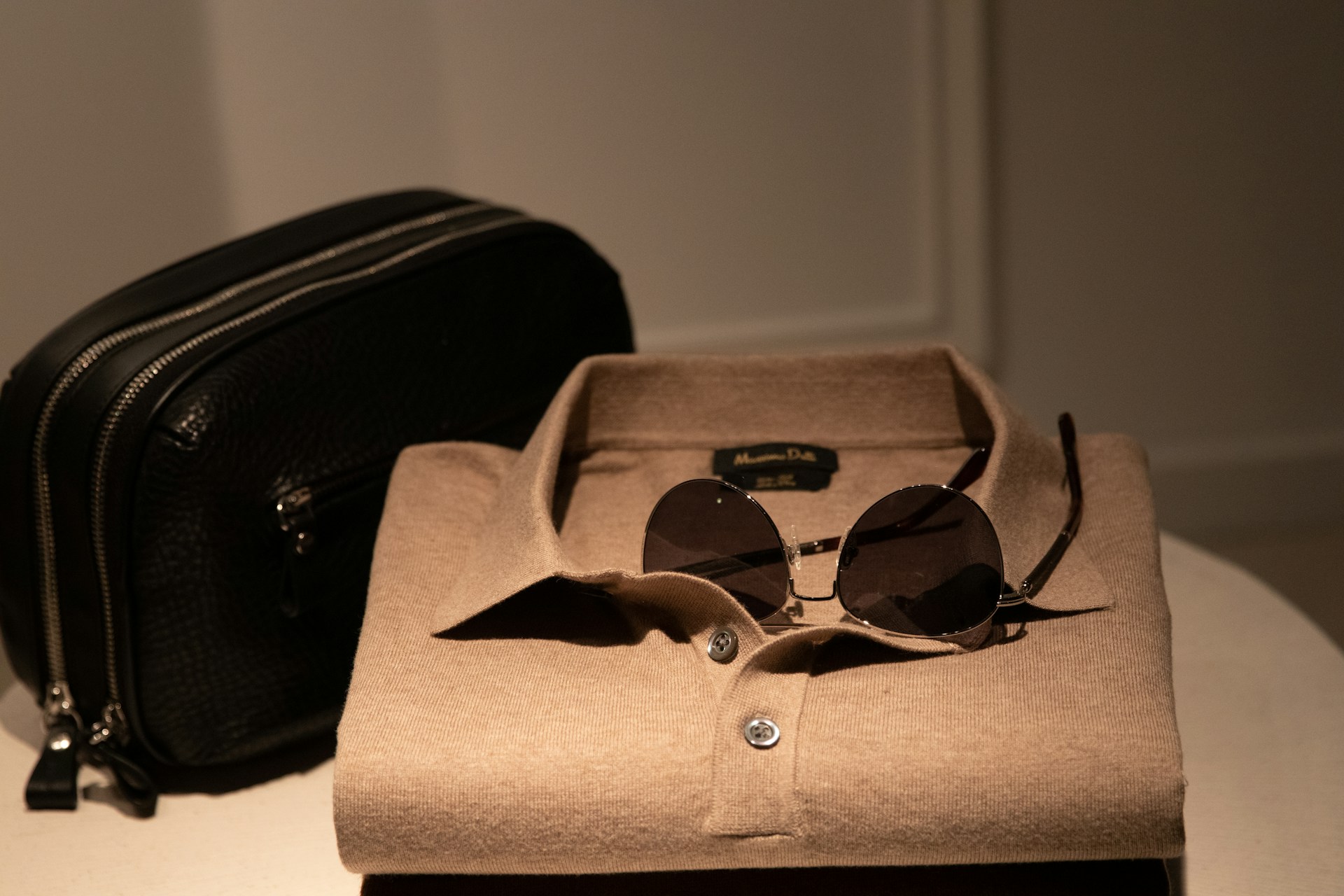 A folded shirt and sunglasses