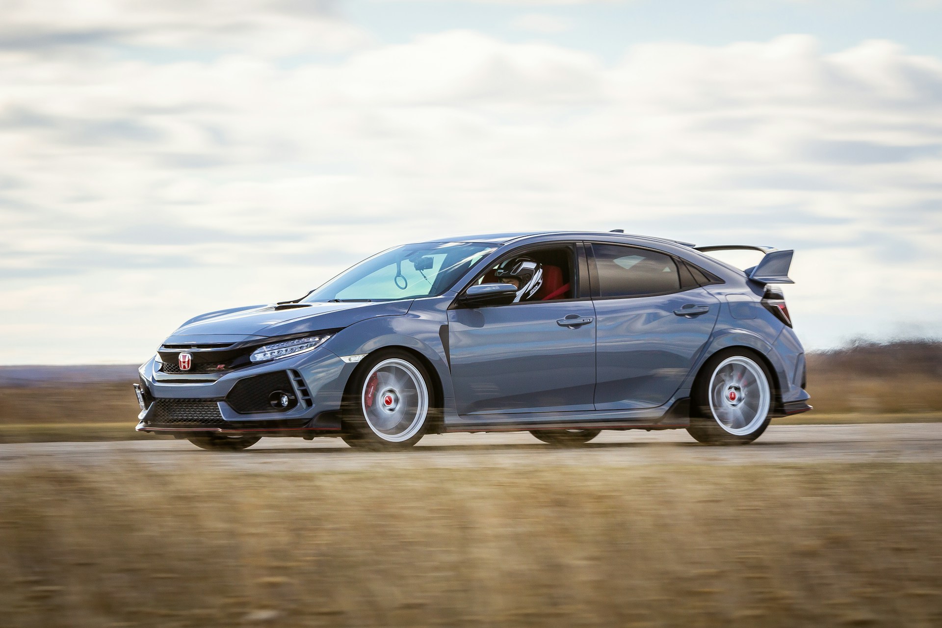 Silver Honda driving along an open road
