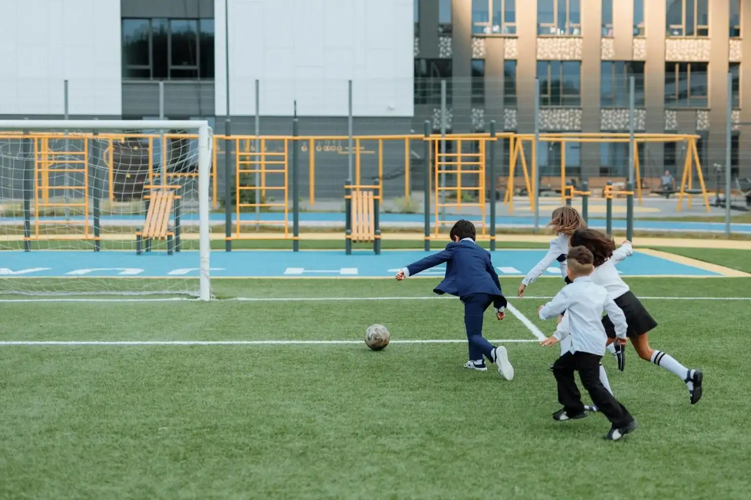 A group of school children playing football