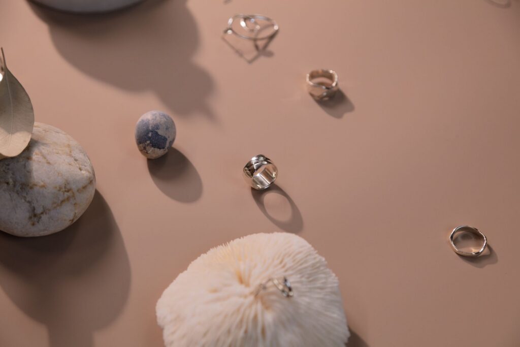 A handful of rings and stones scattered on a tabletop