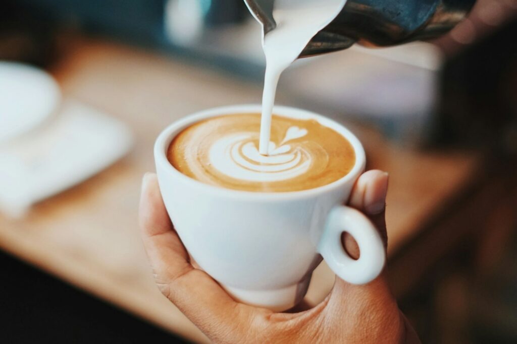 Milk being poured into a coffee