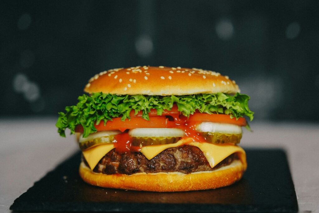 A large cheeseburger with salad toppings